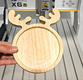 X6M desktop CNC machine carving a wooden fruit bowl from hardwood